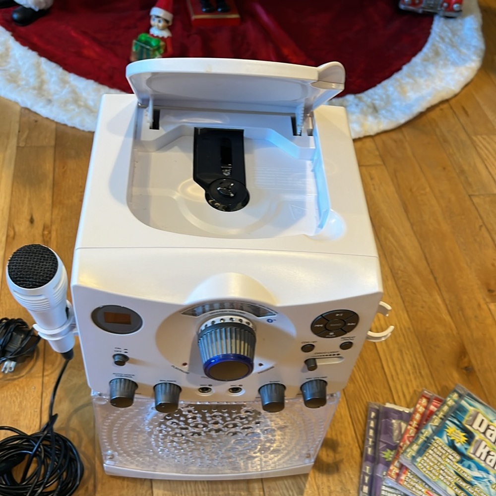 Karaoke machines with CD player. Includes 3 CDs with hits.